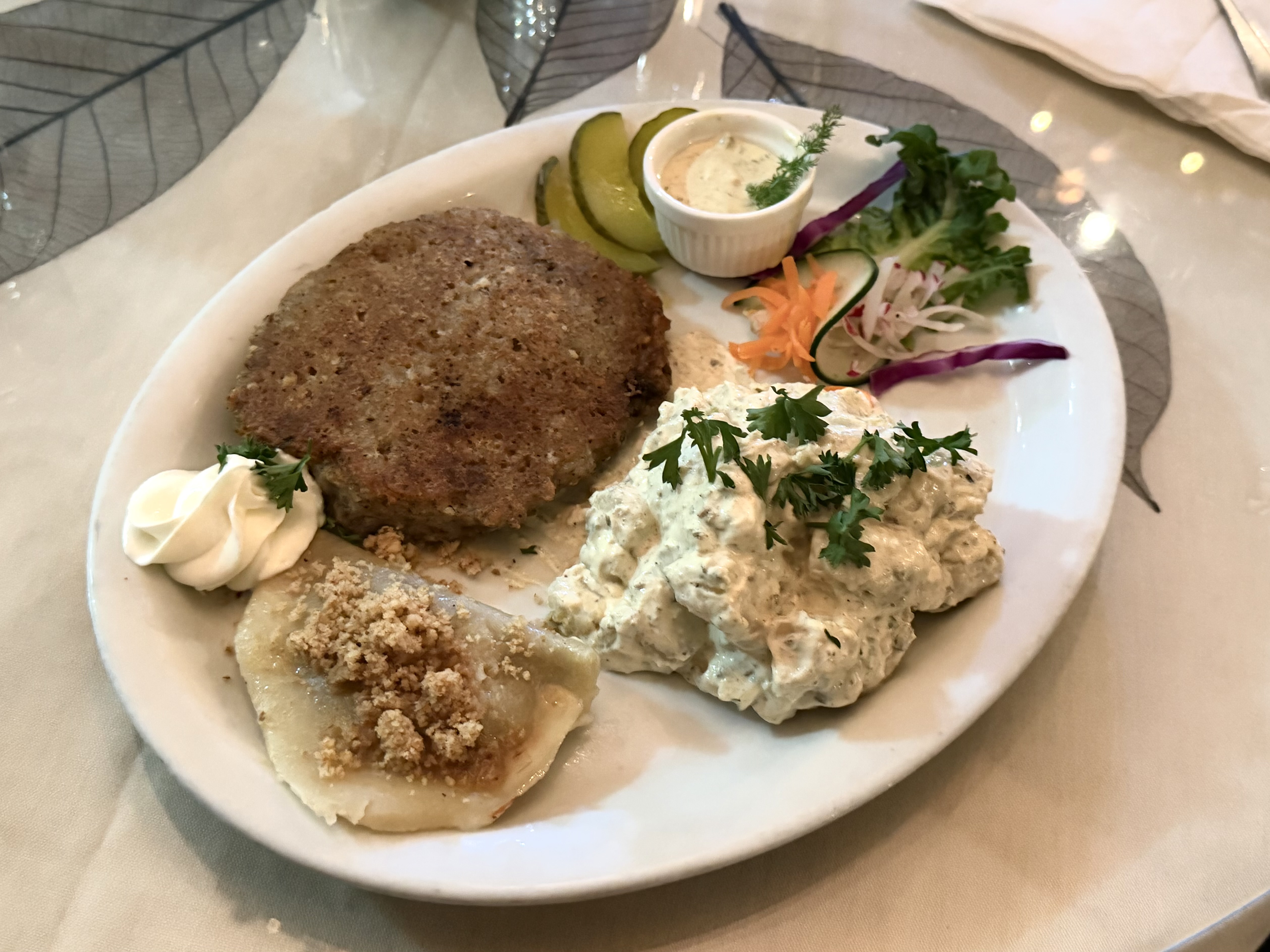 The vegetarian plate at Amadeus — for $23 — consists of a potato pancake, mushroom pierogi and potato salad. Salad and pierogi options vary. Photo by Barrett Dolata (February 17, 2026).